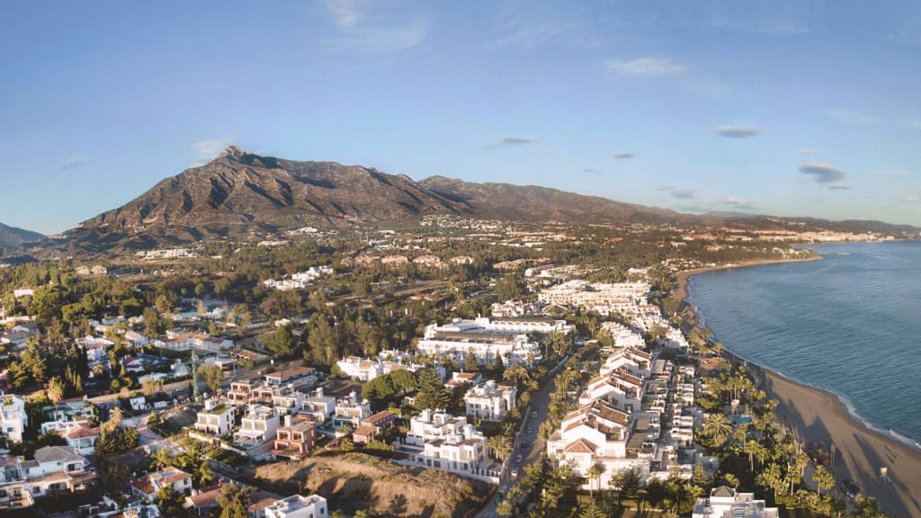 Aerial view of Nueva Andalucía, Marbella with La Concha mountain and coastline – family-friendly neighborhood in Costa del Sol – Quintessentia Property Advisors