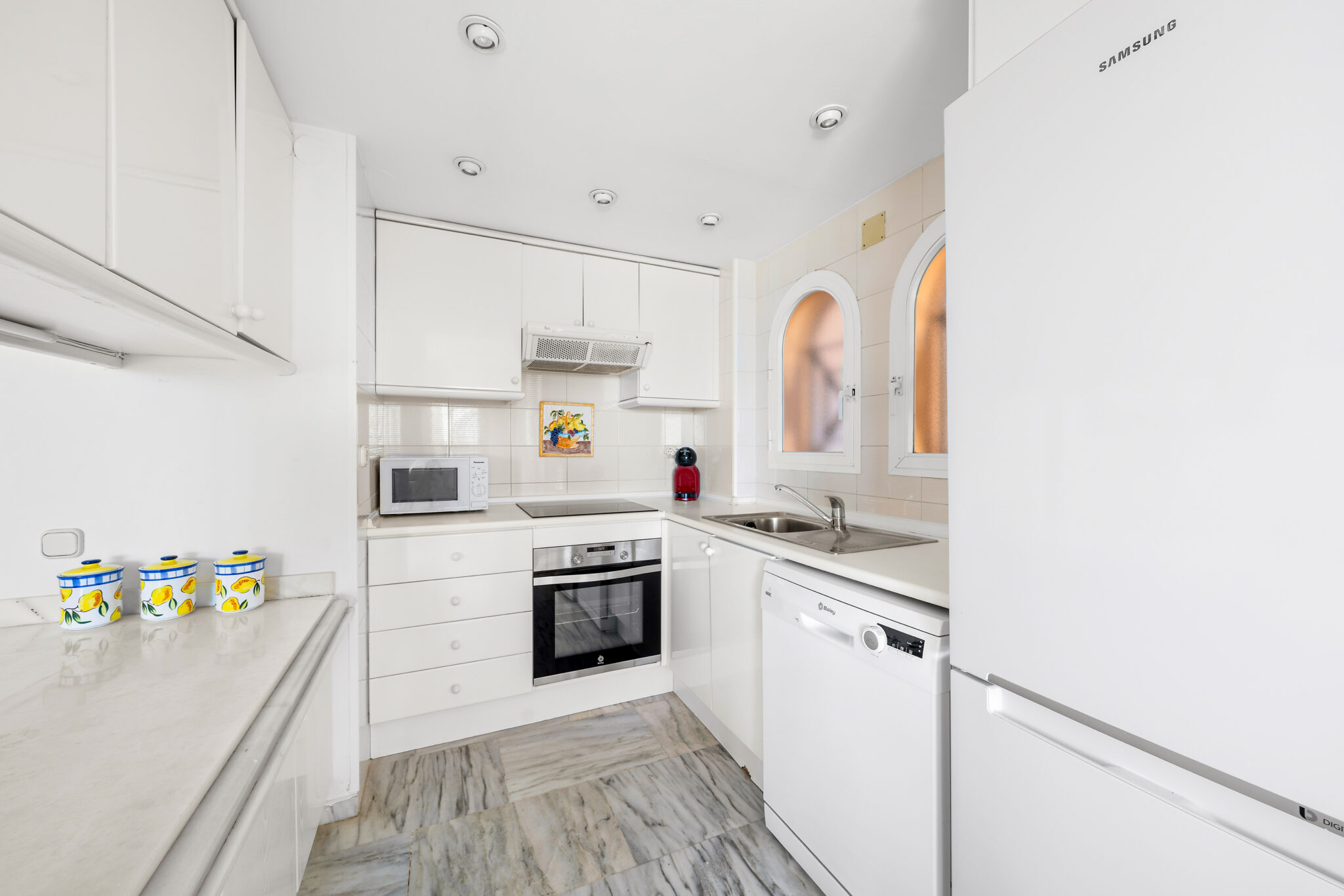 Fully fitted white kitchen in beachfront apartment Estepona