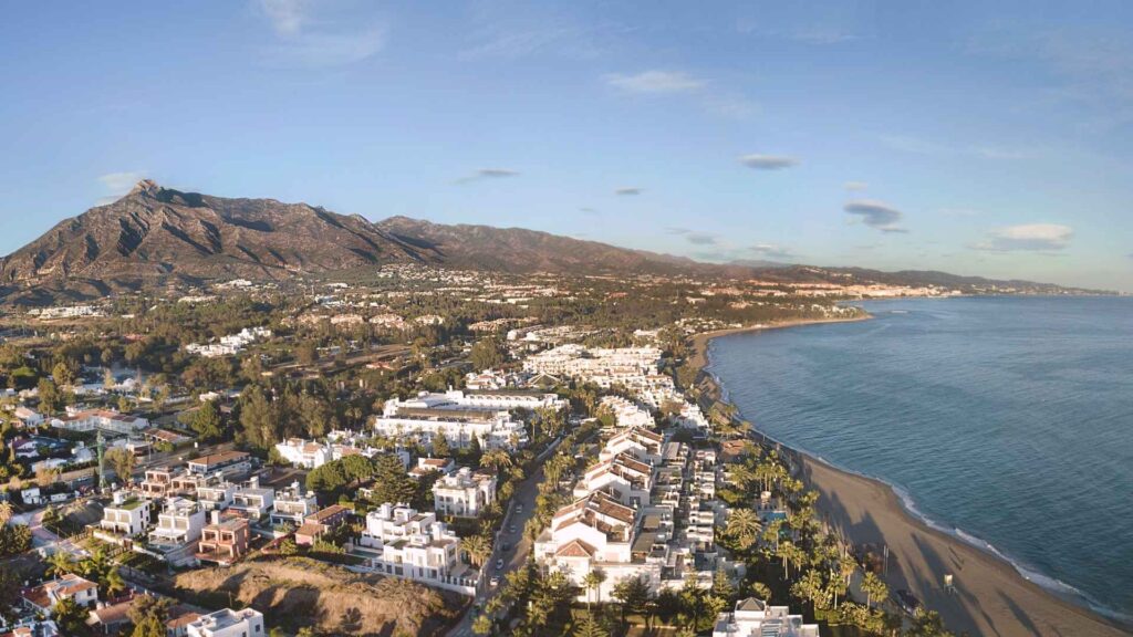 Aerial view of Nueva Andalucía and Marbella coastline with Mediterranean Sea and La Concha mountain in the background.