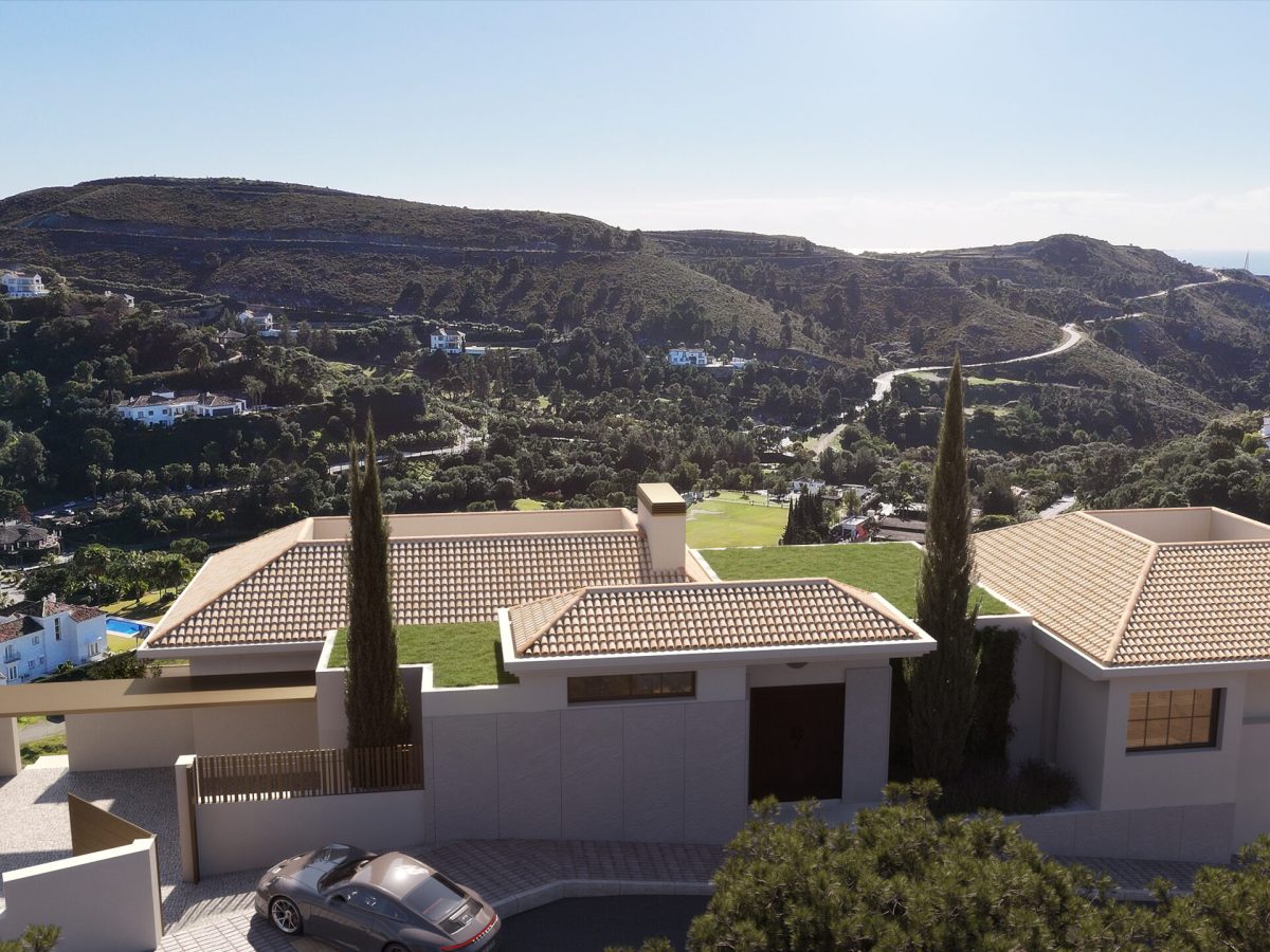 Aerial view of El Quejigal luxury villa entrance in Marbella Club Golf Resort Benahavís surrounded by mountains and golf course.