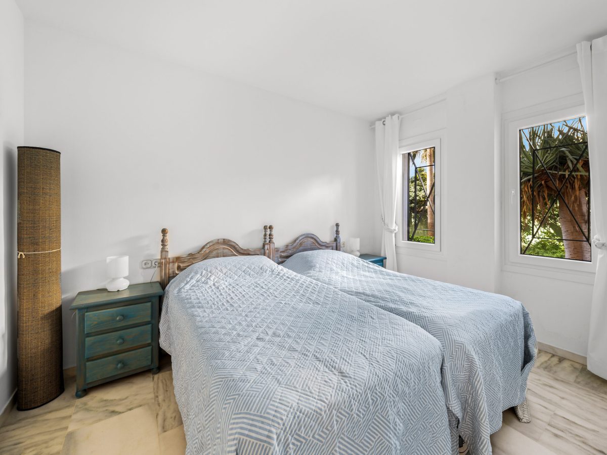 Bright guest bedroom with garden views in Estepona apartment