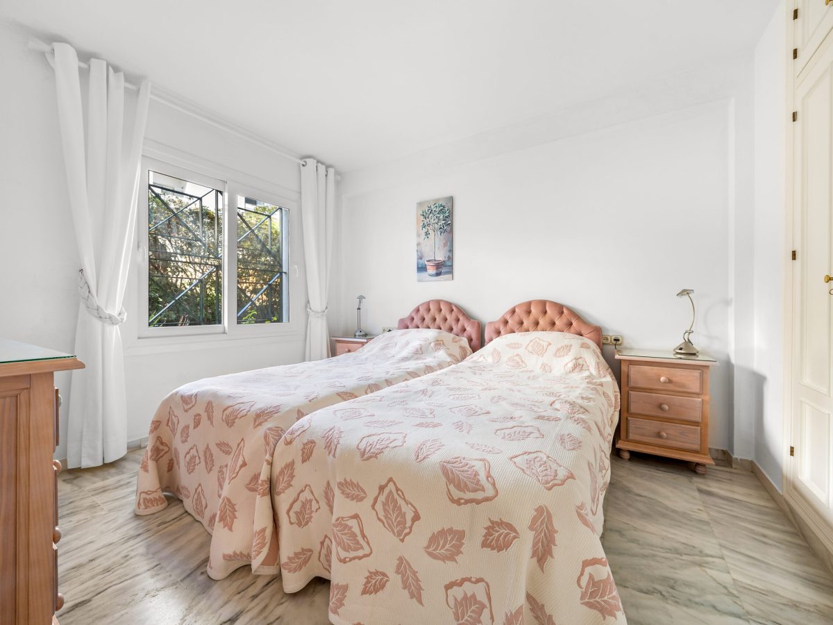 Guest bedroom with large window in Estepona beachfront property
