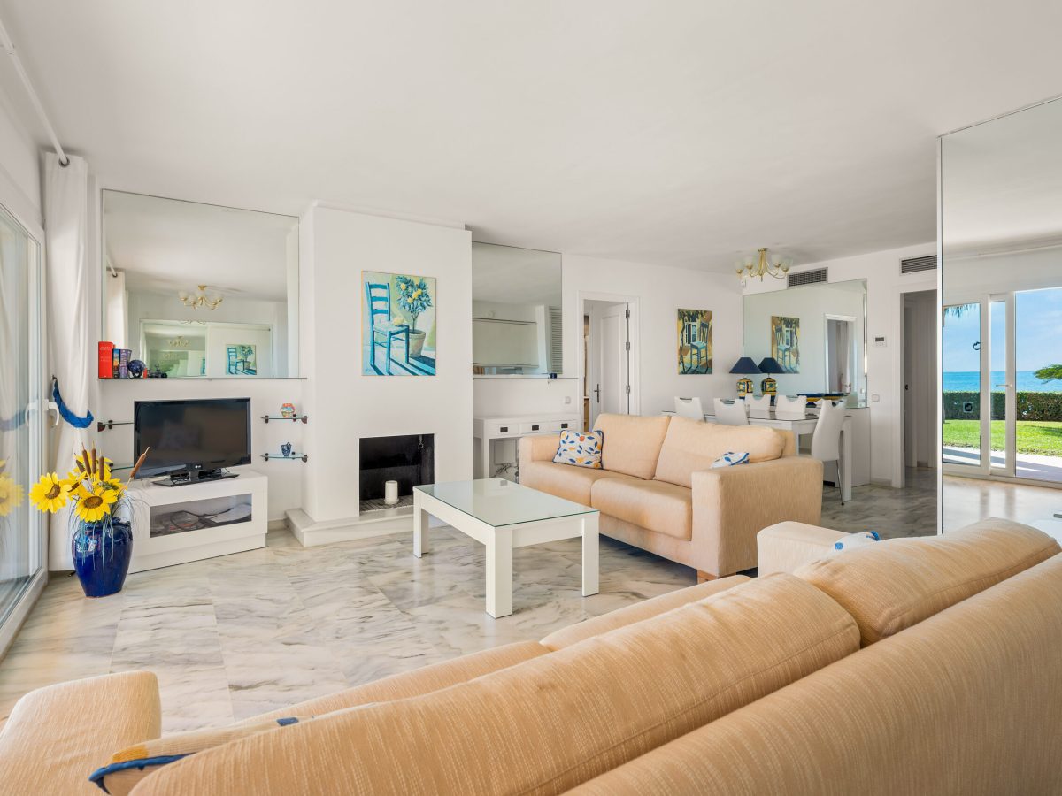 Spacious living room with natural light and terrace views in Estepona property