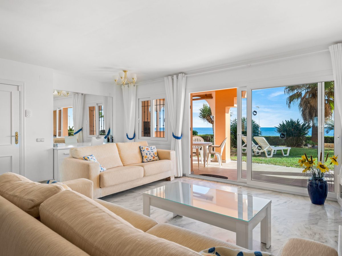 Bright living room with garden access in beachfront apartment Estepona