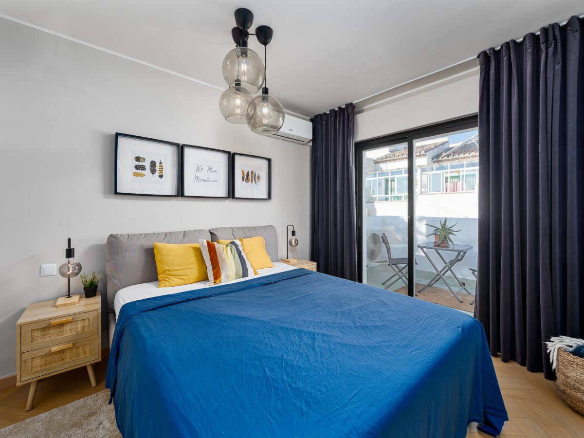 Contemporary bedroom in Bel-Air semi-detached property near Marbella with modern pendant lighting, colorful accents, and balcony access