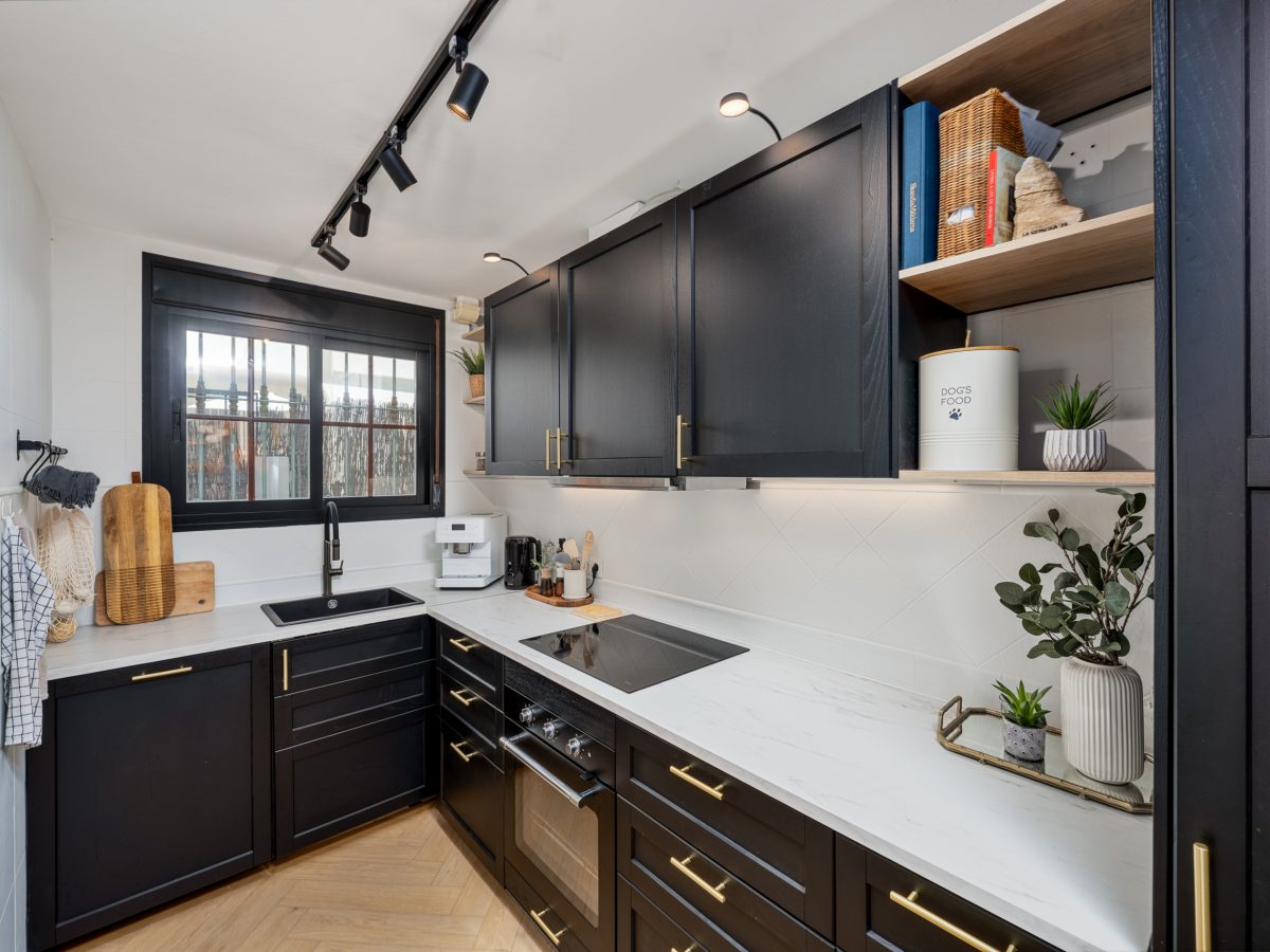 Modern black and white kitchen with gold accents and built-in appliances in Bel-Air semi-detached house, Costa del Sol