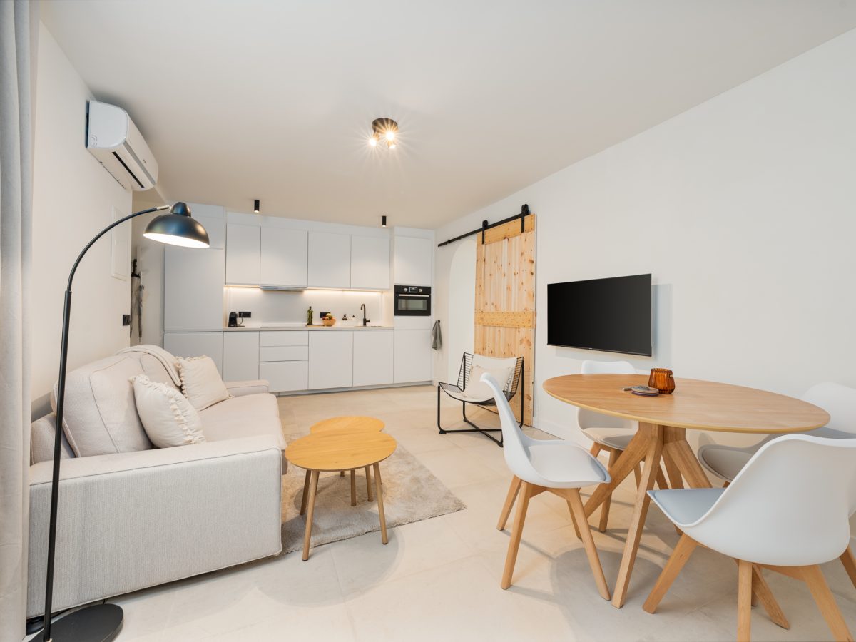 Bright open-plan living room and modern kitchen with Scandinavian decor in Estepona old town apartment