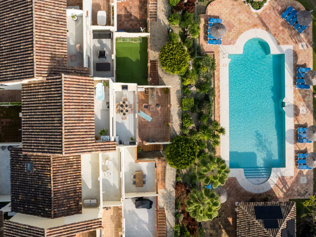 Aerial view of Los Pinos de Aloha with swimming pool and Mediterranean-style architecture in Marbella.