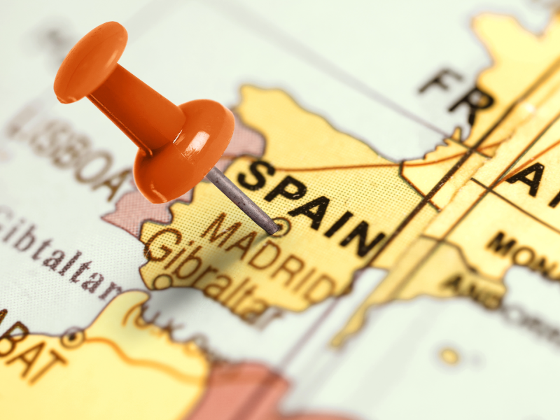 Close-up map of Spain with a red push pin marking Madrid, symbolizing real estate purchase and investment locations in Spain