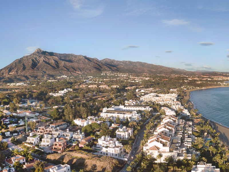 Aerial view of Nueva Andalucía, Marbella with La Concha mountain and coastline – family-friendly neighborhood in Costa del Sol – Quintessentia Property Advisors