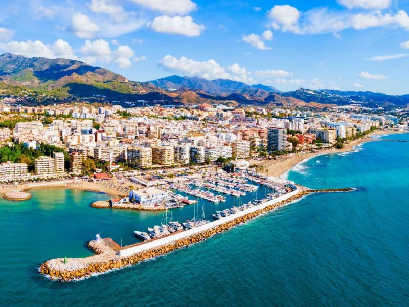 Aerial view of a coastal city in southern Spain showing beaches, marina, and modern apartments along the Costa del Sol, illustrating key Trends in Southern Spain.